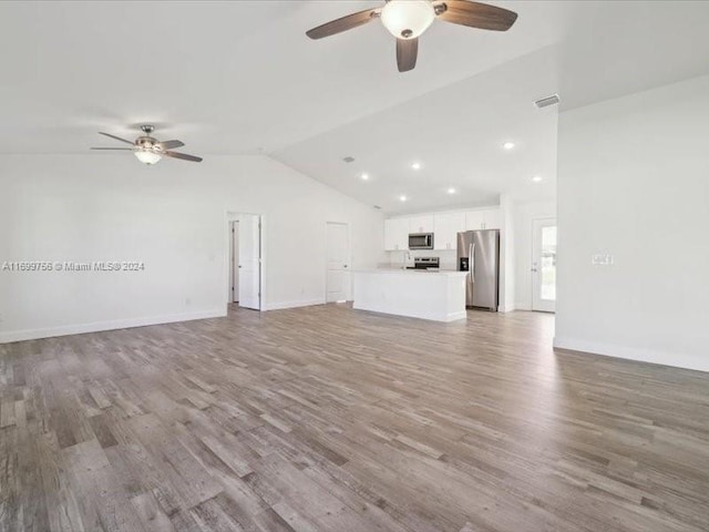 unfurnished living room with hardwood / wood-style floors, ceiling fan, and lofted ceiling