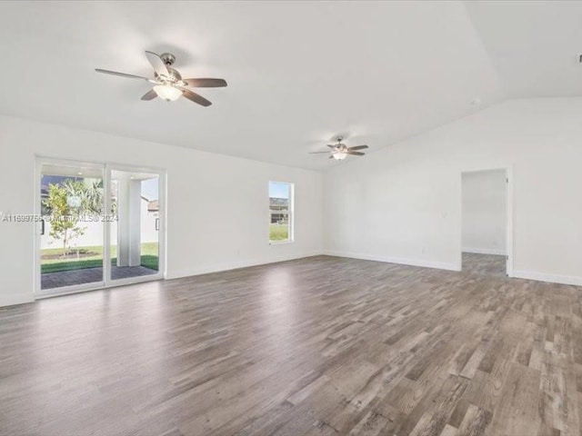 spare room with hardwood / wood-style floors, ceiling fan, and lofted ceiling