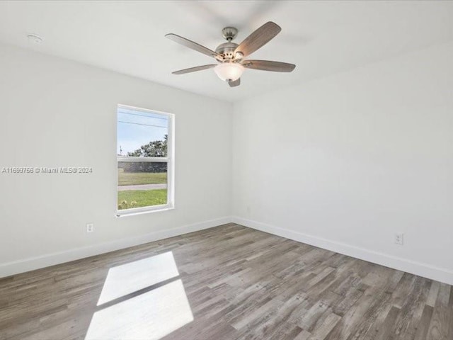 unfurnished room with ceiling fan and light wood-type flooring