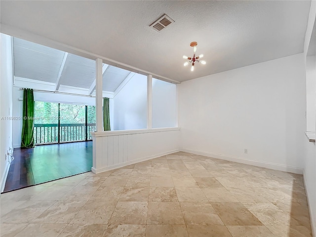 unfurnished room with lofted ceiling, a textured ceiling, and a notable chandelier