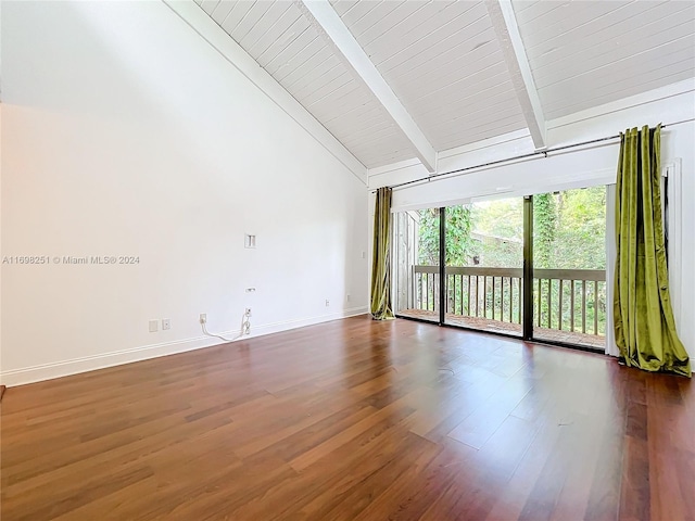 spare room with beamed ceiling, dark wood-type flooring, and high vaulted ceiling