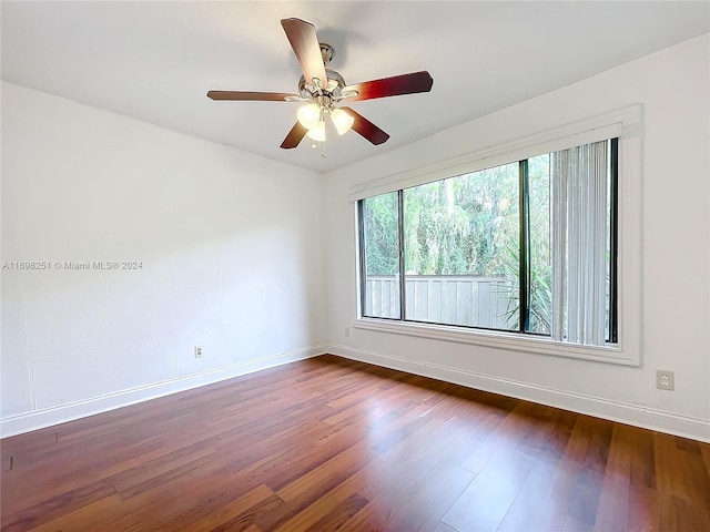 spare room with ceiling fan and dark wood-type flooring