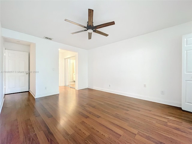 spare room with ceiling fan and dark hardwood / wood-style flooring