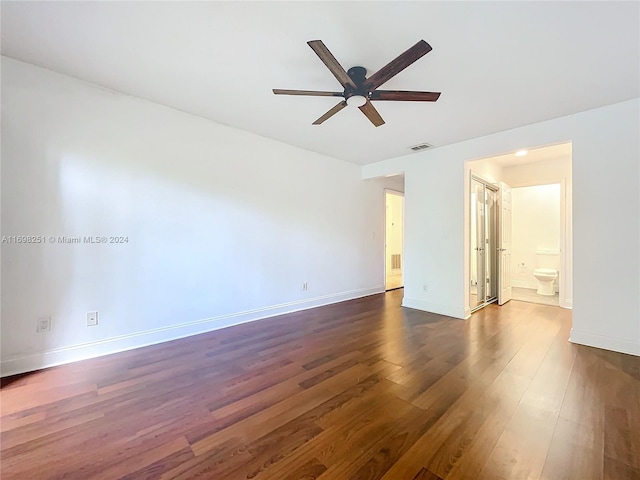 spare room with dark hardwood / wood-style floors and ceiling fan