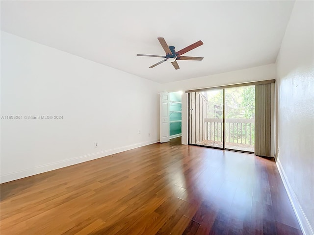 empty room featuring ceiling fan and dark hardwood / wood-style flooring