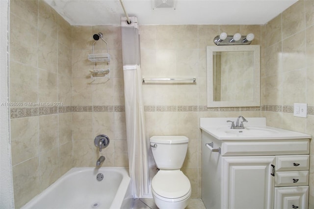 full bathroom with shower / bath combo, vanity, toilet, and tile walls