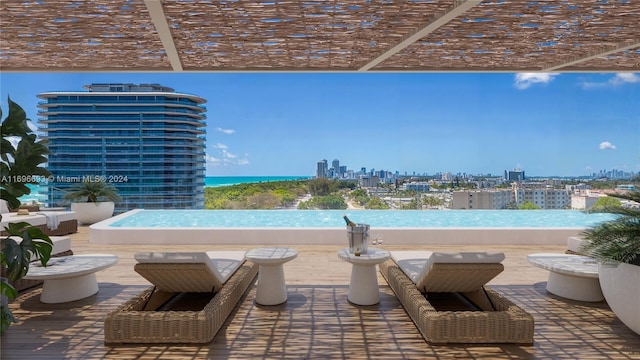 view of swimming pool featuring a pergola and a water view