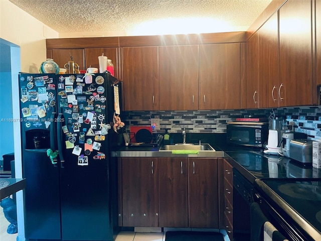 kitchen featuring sink, backsplash, a textured ceiling, and black appliances