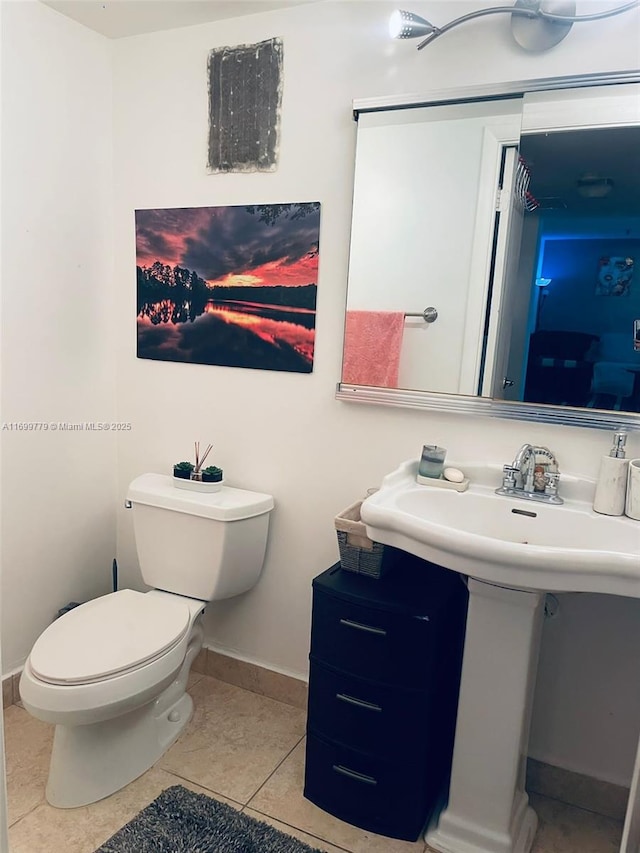 bathroom with tile patterned flooring and toilet