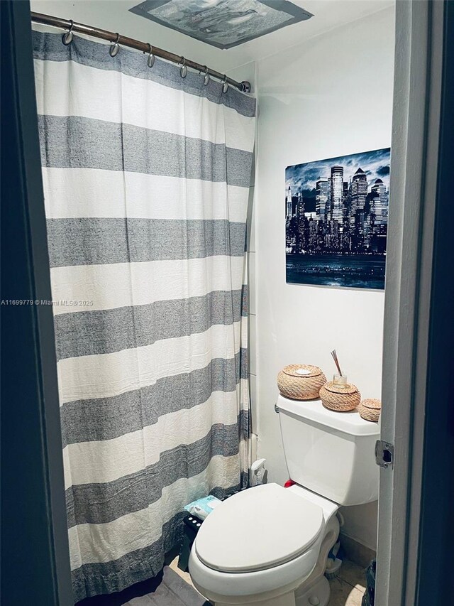 bathroom featuring tile patterned floors and toilet