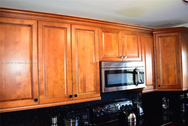 kitchen with decorative backsplash and black stove