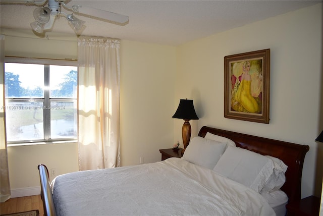 bedroom featuring wood-type flooring and ceiling fan