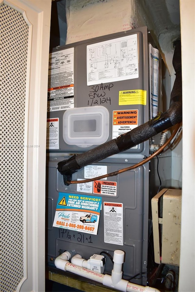 utility room featuring heating unit