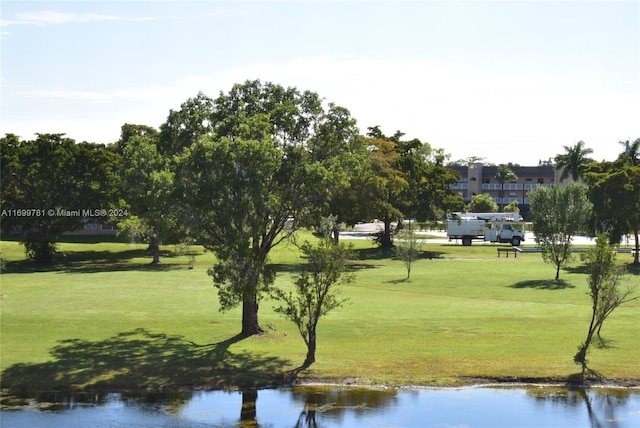 view of home's community with a yard and a water view