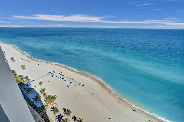 aerial view with a water view and a beach view