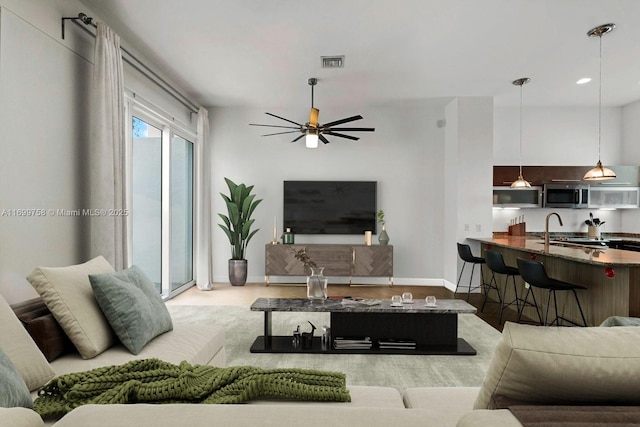 living room with sink and ceiling fan