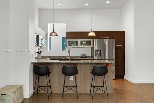 living room with dark parquet floors, ceiling fan, and sink