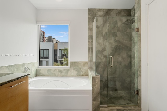 bathroom featuring vanity and independent shower and bath