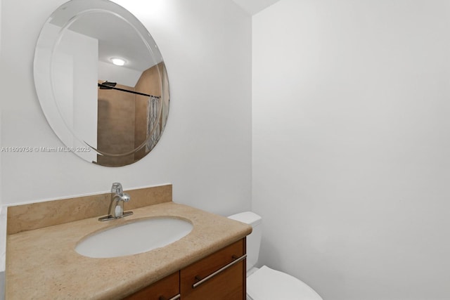 bathroom featuring vanity, a shower with shower curtain, and toilet