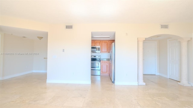 unfurnished room with decorative columns