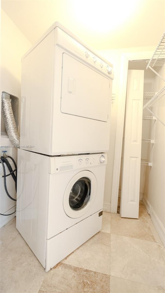 washroom with stacked washer / dryer