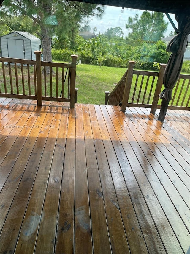 deck with a lawn and a shed