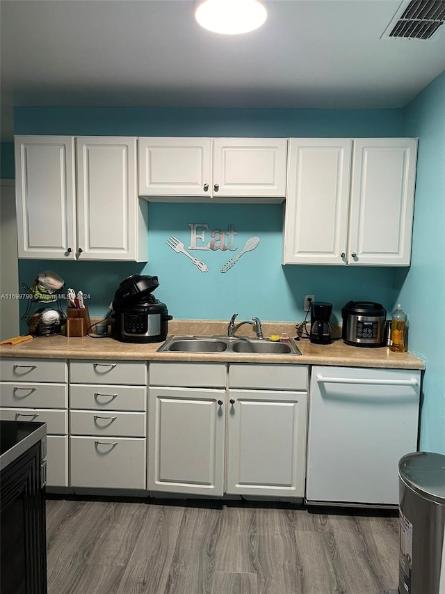 kitchen with white cabinets, dishwasher, sink, and dark wood-type flooring