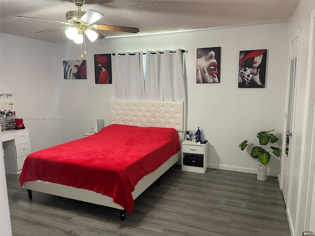 bedroom with a textured ceiling, ceiling fan, and dark hardwood / wood-style floors