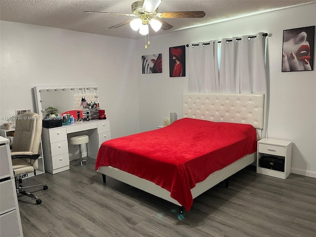 bedroom with ceiling fan, dark hardwood / wood-style flooring, and a textured ceiling