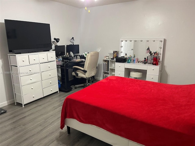 bedroom with hardwood / wood-style floors and a textured ceiling