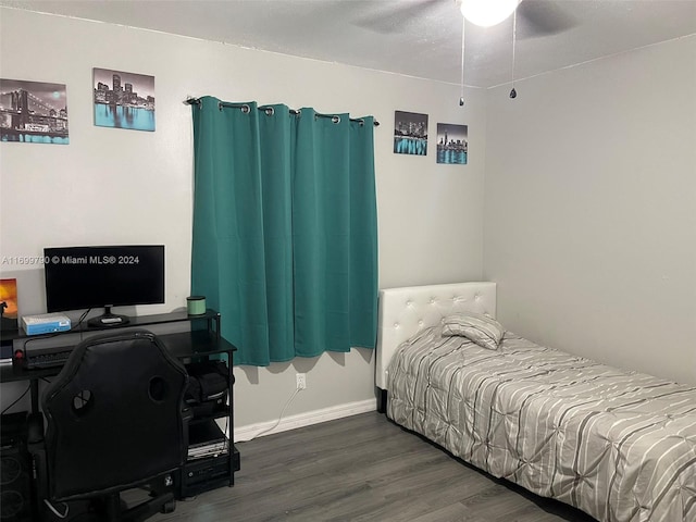 bedroom with ceiling fan and dark wood-type flooring