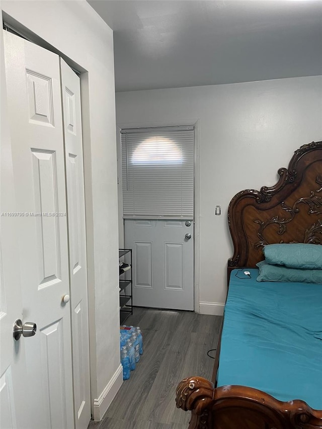 bedroom featuring dark wood-type flooring and a closet