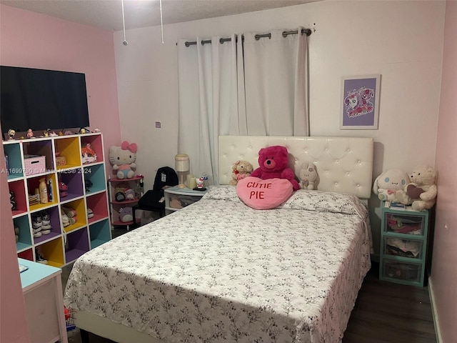 bedroom featuring dark hardwood / wood-style flooring