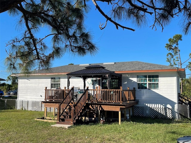 back of house featuring a gazebo, a yard, and a wooden deck