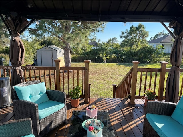 wooden terrace featuring a shed and a lawn