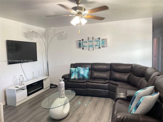 living room with ceiling fan and wood-type flooring