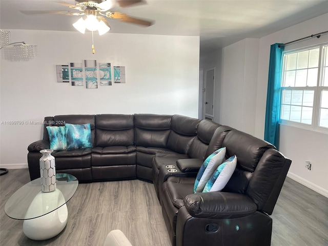 living room featuring hardwood / wood-style floors and ceiling fan