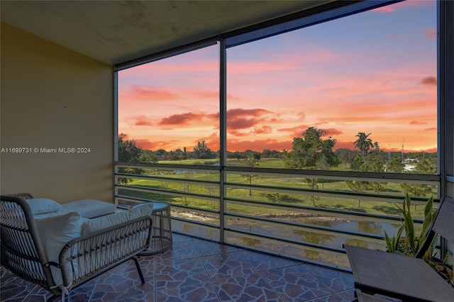 sunroom with a water view and a healthy amount of sunlight