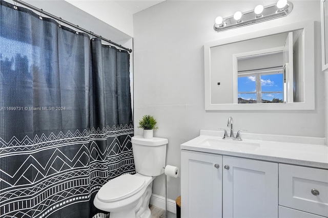 bathroom with a shower with curtain, vanity, and toilet