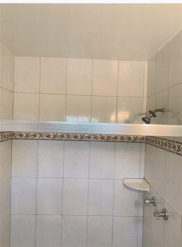 bathroom with a tile shower