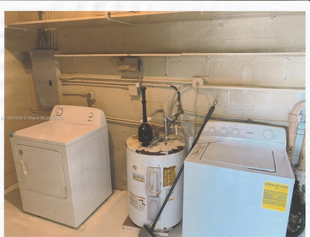 laundry room featuring washing machine and dryer, electric panel, and water heater