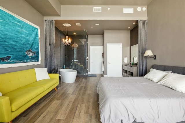 bedroom featuring hardwood / wood-style flooring and a chandelier