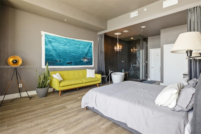 bedroom with hardwood / wood-style flooring and a chandelier