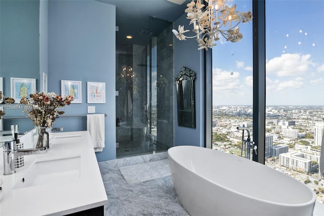 bathroom featuring vanity, shower with separate bathtub, and a wealth of natural light