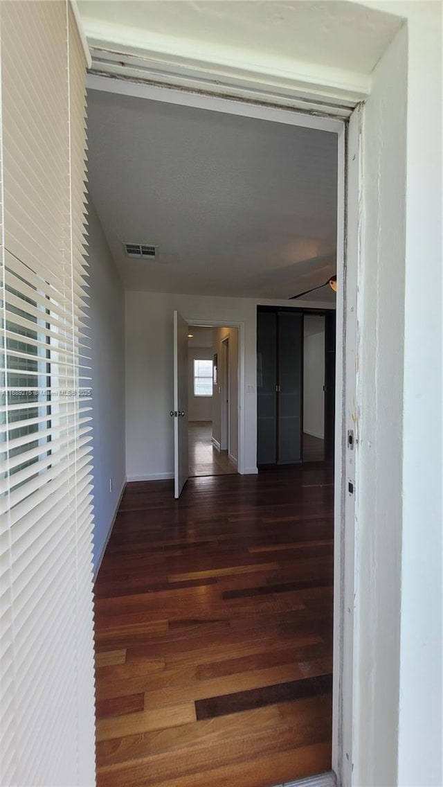 hallway with dark hardwood / wood-style floors