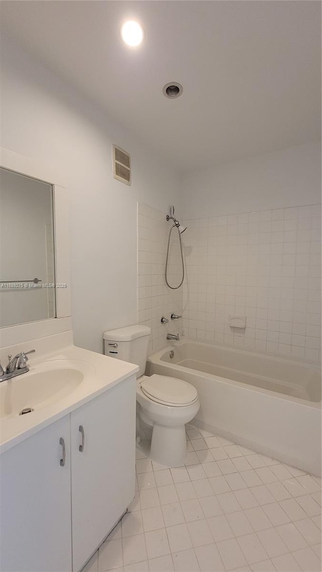 full bathroom with tile patterned flooring, vanity, toilet, and tiled shower / bath