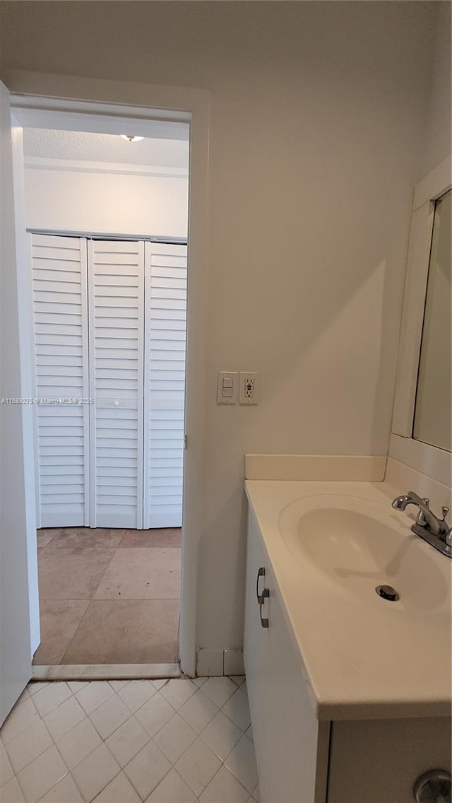 bathroom featuring tile patterned flooring and vanity