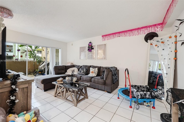 living room featuring light tile patterned floors, a textured ceiling, and plenty of natural light