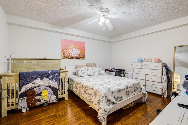 bedroom with dark hardwood / wood-style floors, ceiling fan, and a textured ceiling