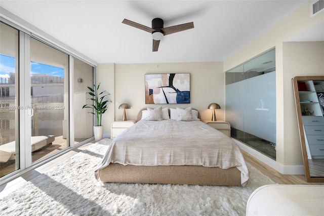 bedroom with ceiling fan, light hardwood / wood-style floors, and access to exterior